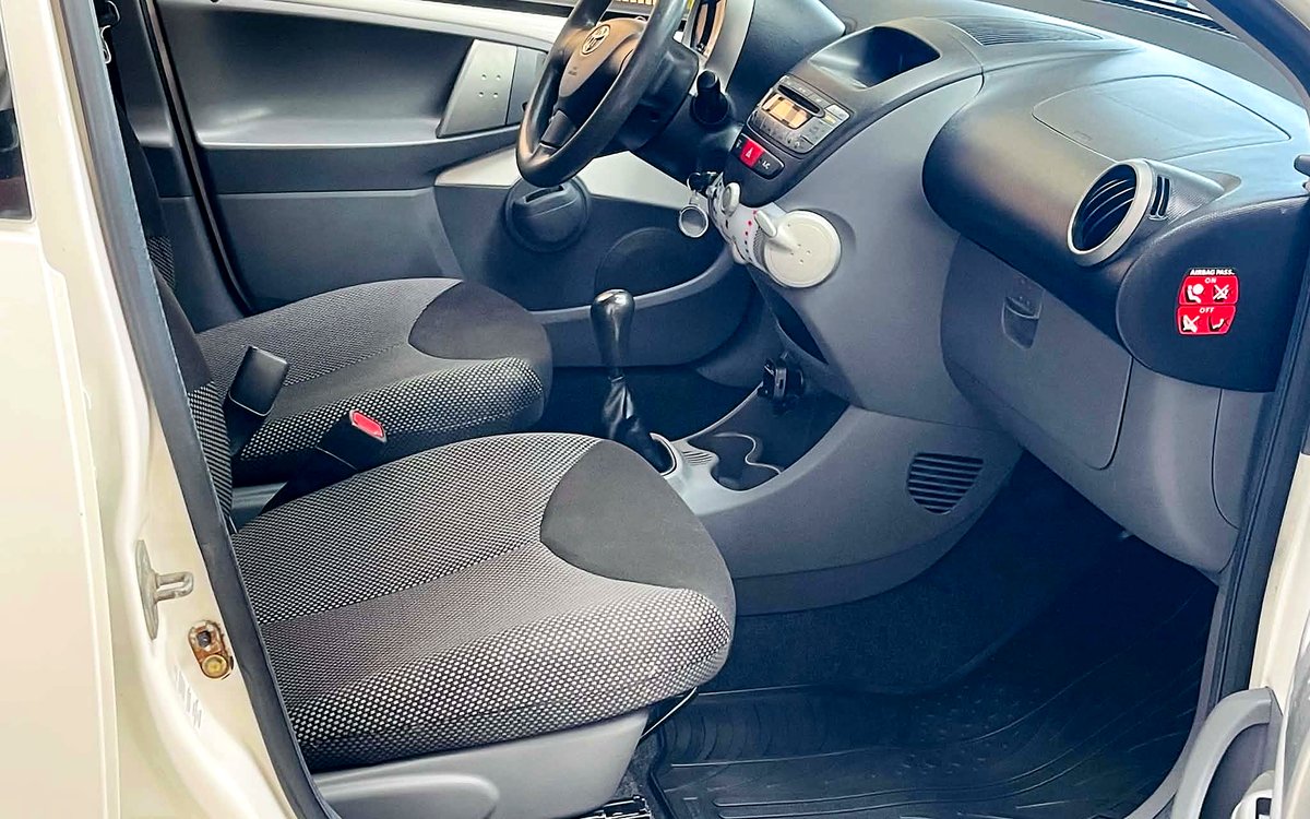 Førerpladsen i den hvide Toyota Aygo med stofsæder